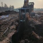 Dichtbahnpflug zieht Folie in Boden